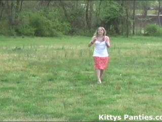 Petite 18 year old teen Kitty got a new kite and she wants to go out into a field and try it out. Kitty looks so cute running around in her little skirt and trying to get her kite in the air.