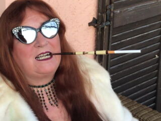 Fetish smoker and slut wife Augusta wears her furs smoking with long cigarette holders, often in public in front of the neighbours in her lake home. She feels sexy!